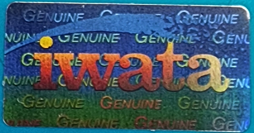Closeup of genuine iwata hologram with swoosh above logo